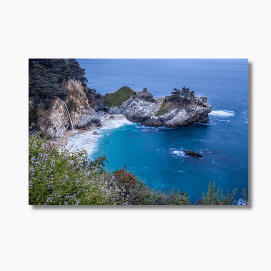 A fine art photograph of McWay Falls in Big Sur, California, cascading into the Pacific Ocean at golden hour. Limited edition coastal wall art print.
