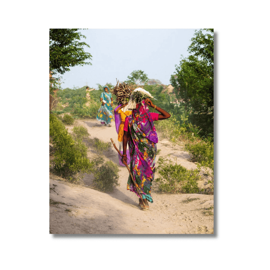 Women in colourful sarees carrying firewood through a dirt path in Agra, India — limited edition cultural fine art photography print.