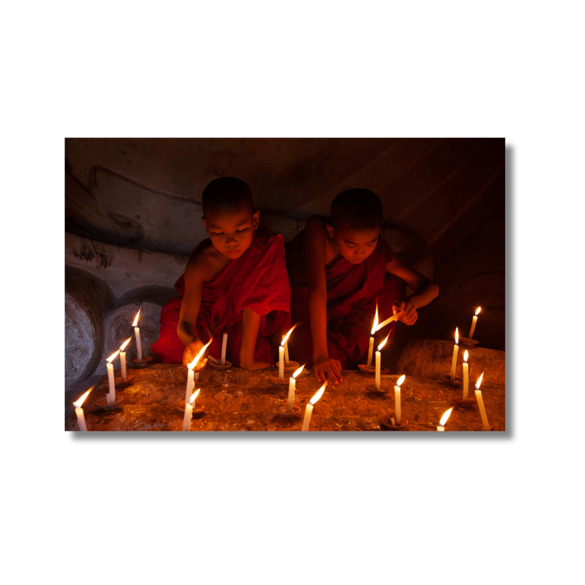 Monks lighting candles inside a temple in Bagan, Myanmar — limited edition spiritual fine art photography wall print.