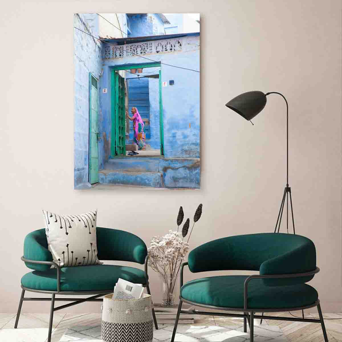 Fine art wall print of a woman in soft purples walking through blue alleyways of Jodhpur, displayed in a serene, global-inspired interior.