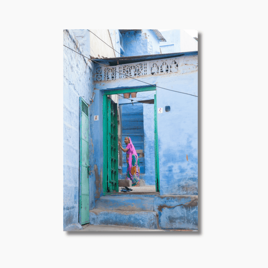 An elderly woman in purple clothing walking through blue-washed alleyways in Jodhpur, India — limited edition fine art photography print.