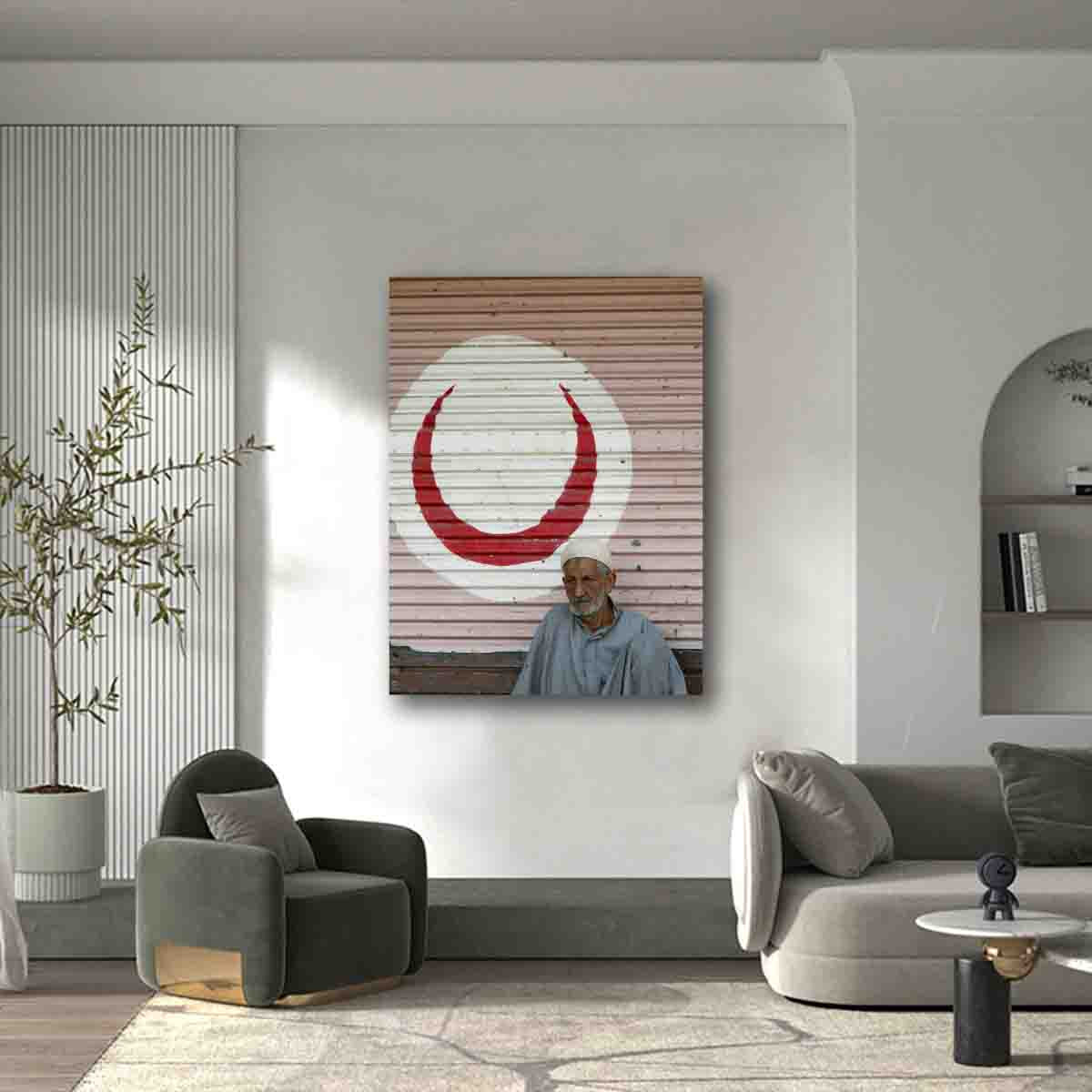 Cairo street portrait of man in front of red crescent, displayed in a modern cultural-inspired interior.