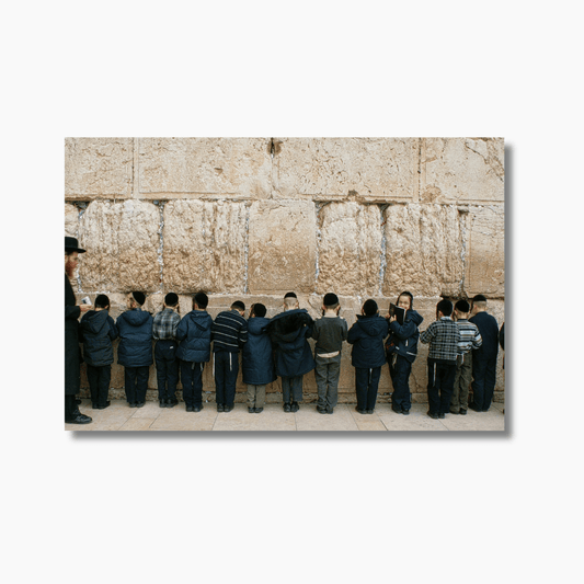 A person praying at the Western Wall in Jerusalem, Israel. Limited edition fine art photography print by Dan Lewin.