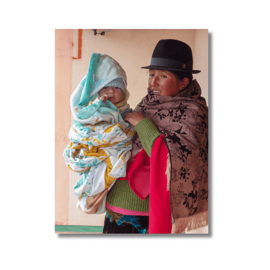 Mother holding baby in traditional Ecuadorian clothing at Laguna Quilotoa — limited edition fine art photography wall print.