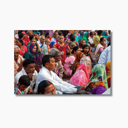 Girl in red standing still amid a crowd during Ganga Aarti ceremony in Haridwar, India — limited edition fine art cultural photography print.