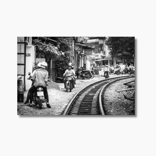 Street scene in Hanoi with mopeds riding past train tracks — limited edition Vietnam street photography wall art print.
