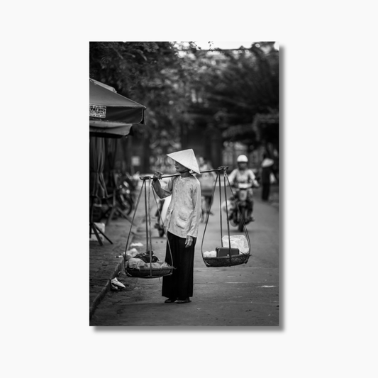 Vietnamese woman balancing goods with a bamboo pole in Hoi An — limited edition cultural photography fine art wall print.