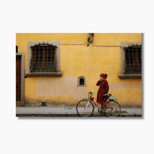 Person standing with red bicycle and phone on a quiet Italian street — limited edition Italy street photography wall art print.