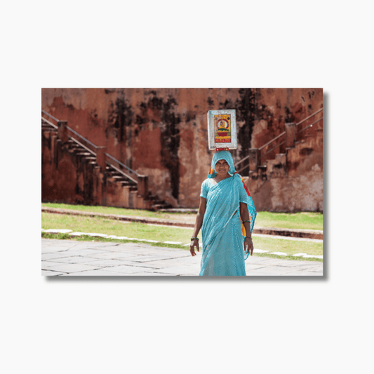 Indian woman in turquoise saree carrying container on her head in Jaipur — limited edition cultural fine art photography print.