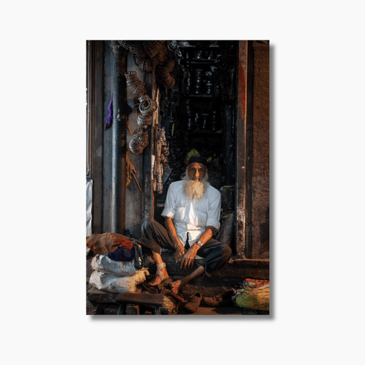 Portrait of an elderly Indian man sitting in the doorway of his shop in Jodhpur — limited edition fine art photography wall print.
