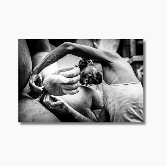 Indian sculptor working with clay in Kumartuli, Kolkata — limited edition cultural photography print capturing traditional craftsmanship.