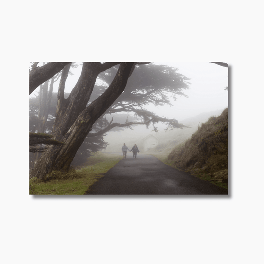Couple walking hand in hand through morning fog at Point Reyes, California — limited edition fine art photography wall print.