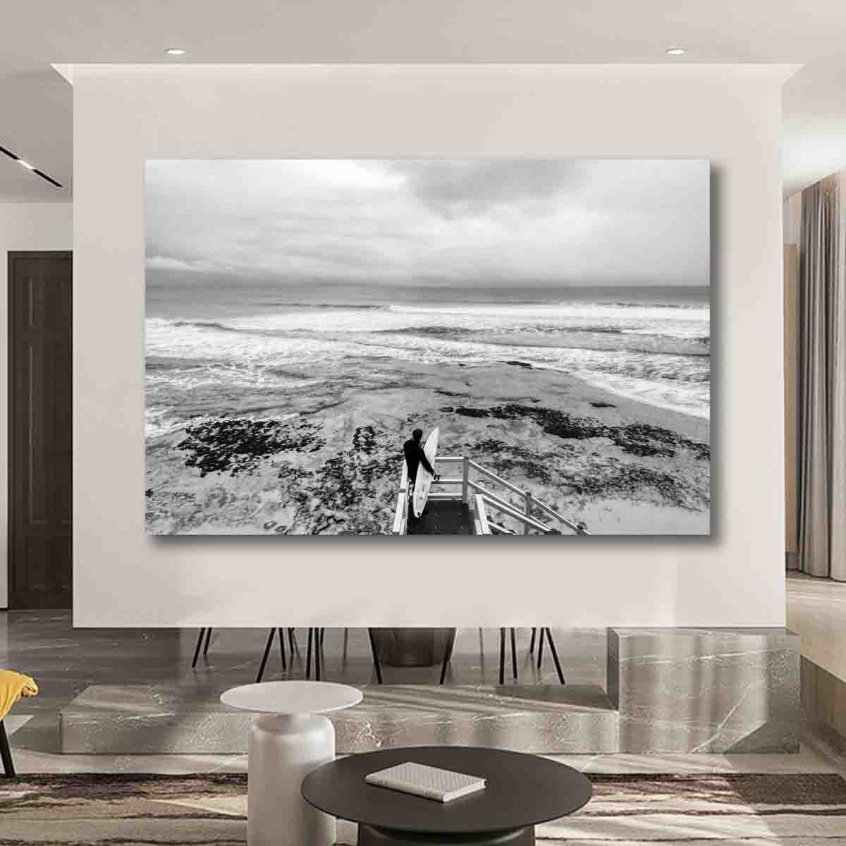 Surf photography wall art featuring a lone surfer at Torquay beach, displayed in a coastal-inspired modern interior.