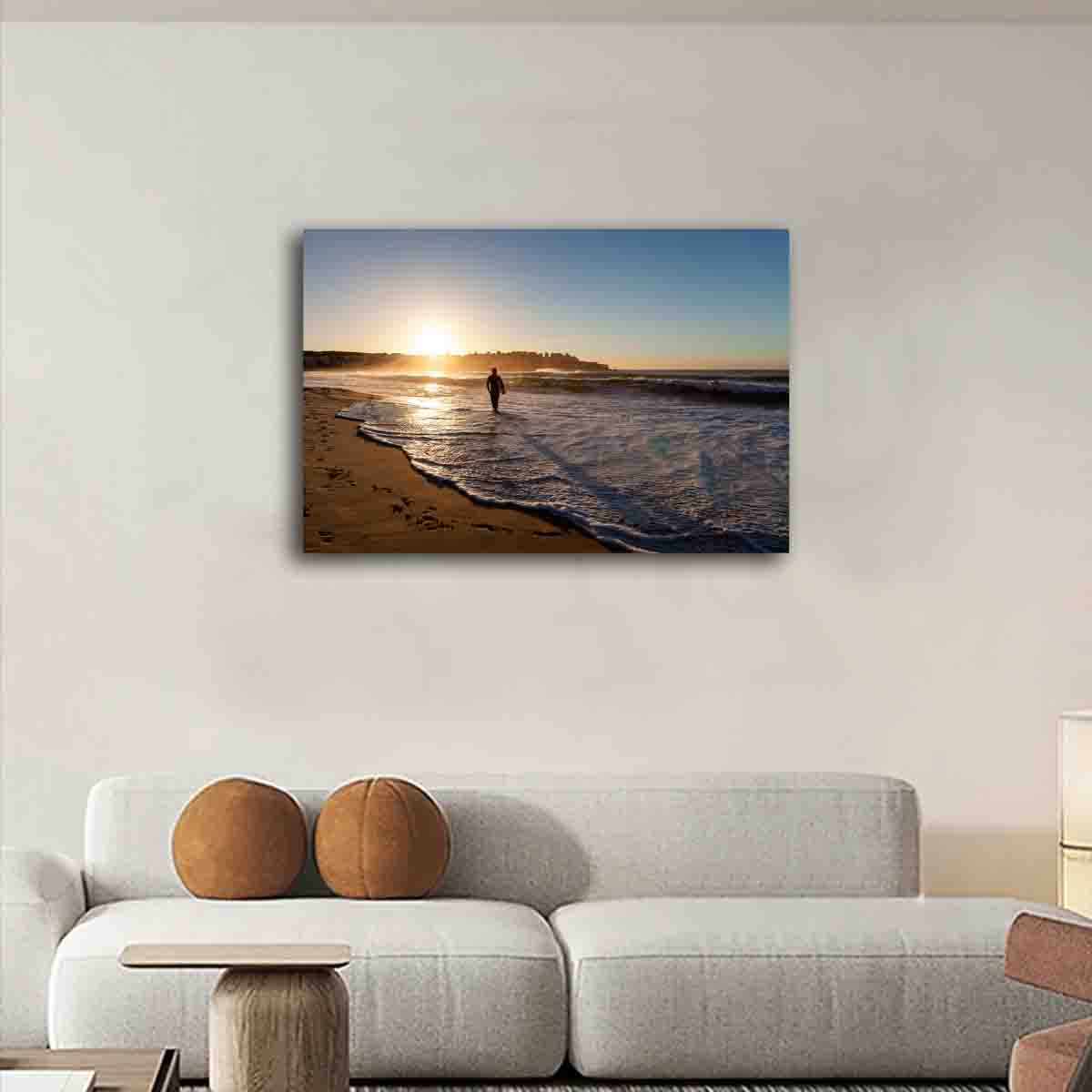 Fine art sunrise photography print of surfer at Bondi Beach, displayed in a calm, coastal-inspired modern interior.