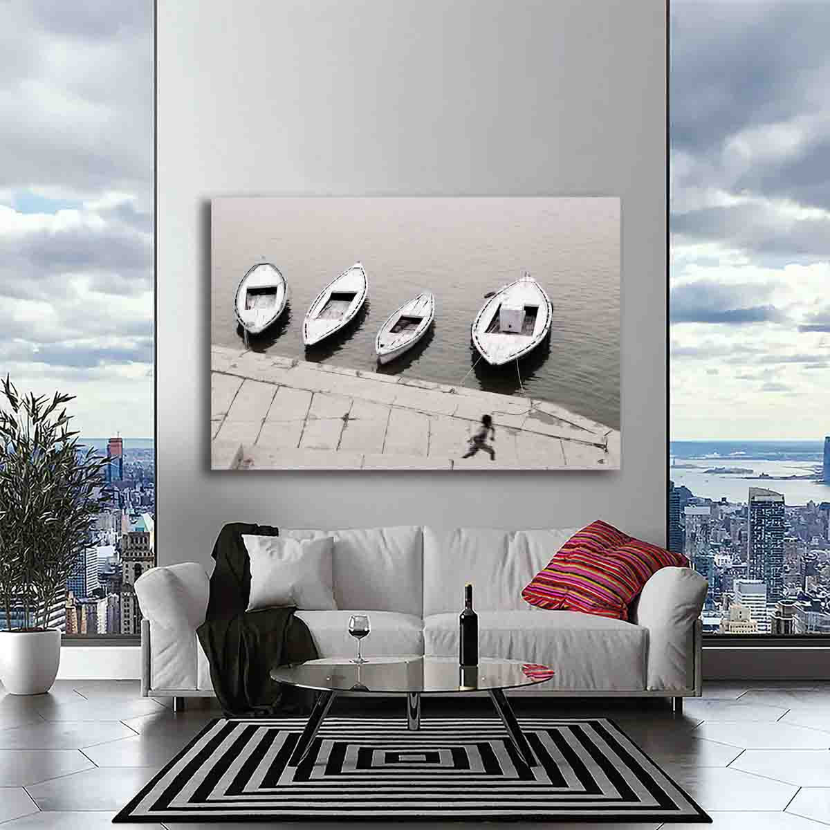 Varanasi riverside photography print of boy running by boats, displayed in a rustic, story-driven interior space.