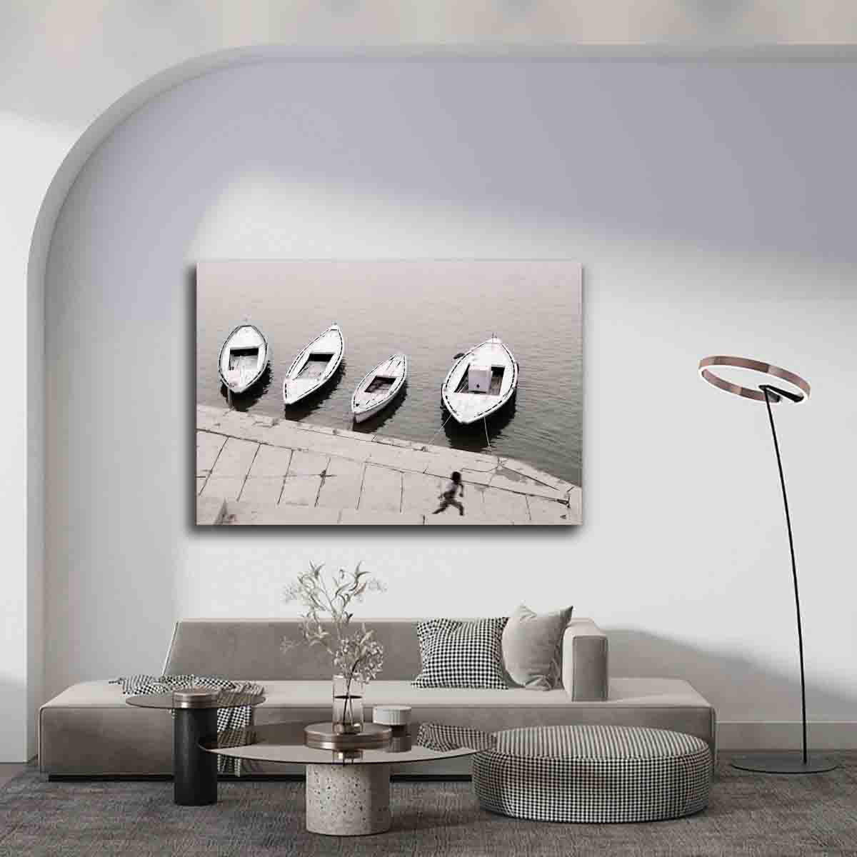 Varanasi riverside photography print of boy running by boats, displayed in a rustic, story-driven interior space.