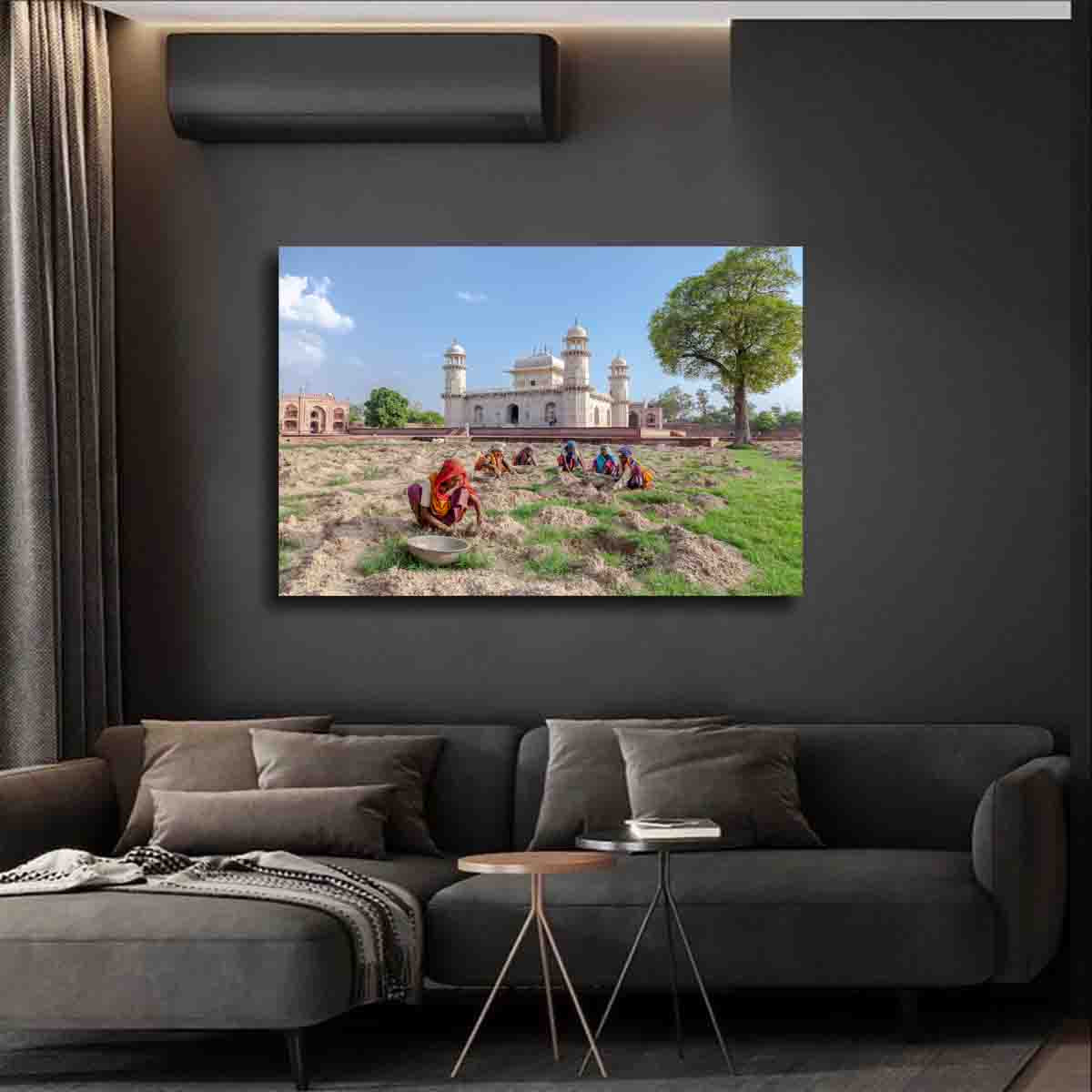 Cultural fine art print showing women in Agra collecting rocks near the Baby Taj Mahal, displayed in a modern global-inspired interior.