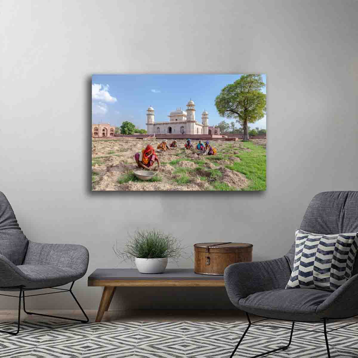 Cultural fine art print showing women in Agra collecting rocks near the Baby Taj Mahal, displayed in a modern global-inspired interior.