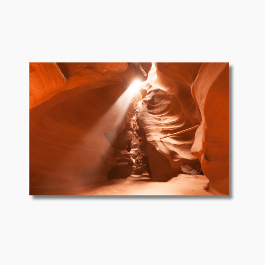 Sunlight streaming through the narrow passage of Antelope Canyon, illuminating the desert landscape with a stunning ray of light.