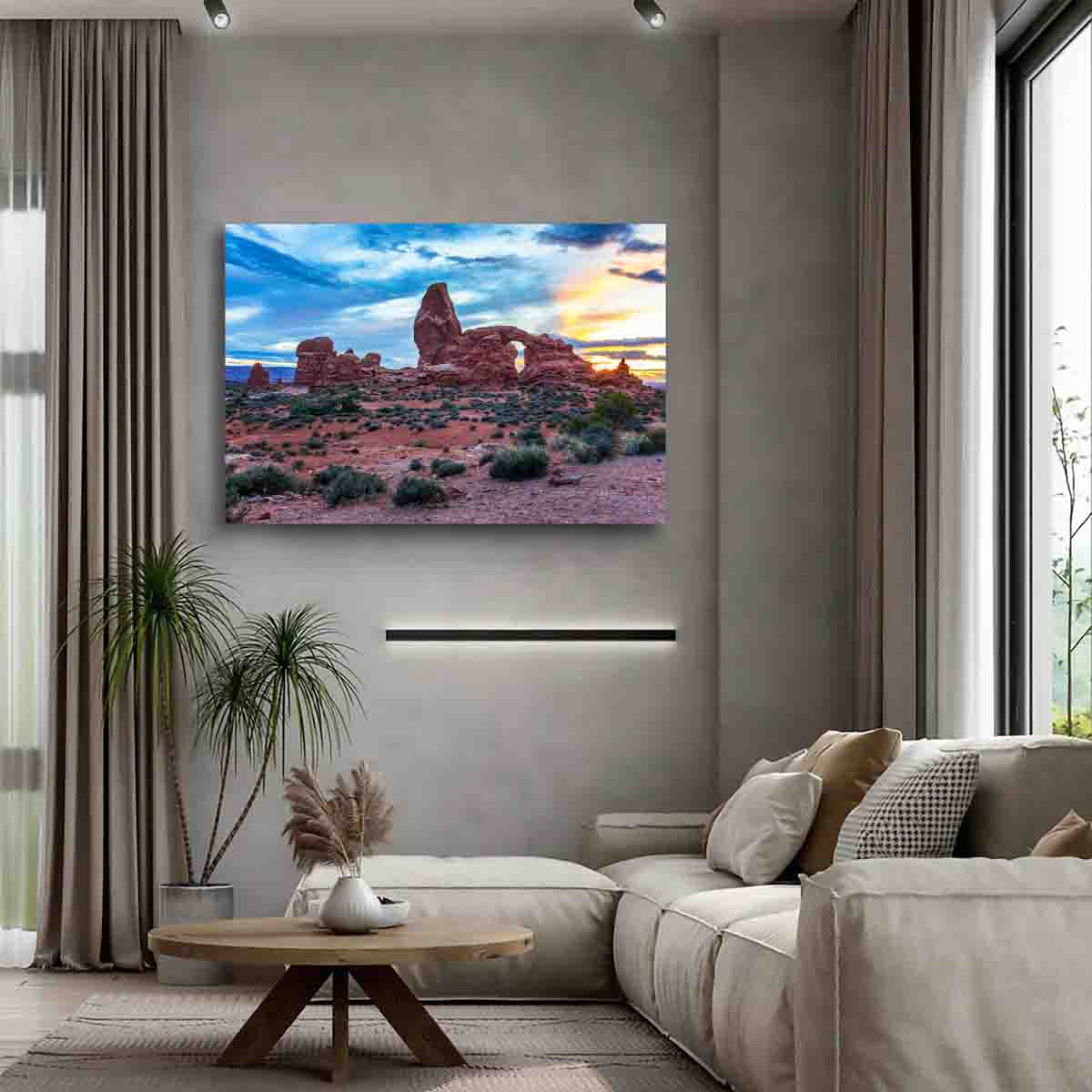 Desert landscape print of Arches National Park glowing at golden hour, displayed in a warm-toned modern interior.
