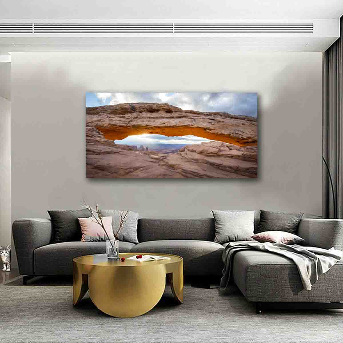 Mesa Arch sunrise canvas wall art displayed in modern living room with natural light.