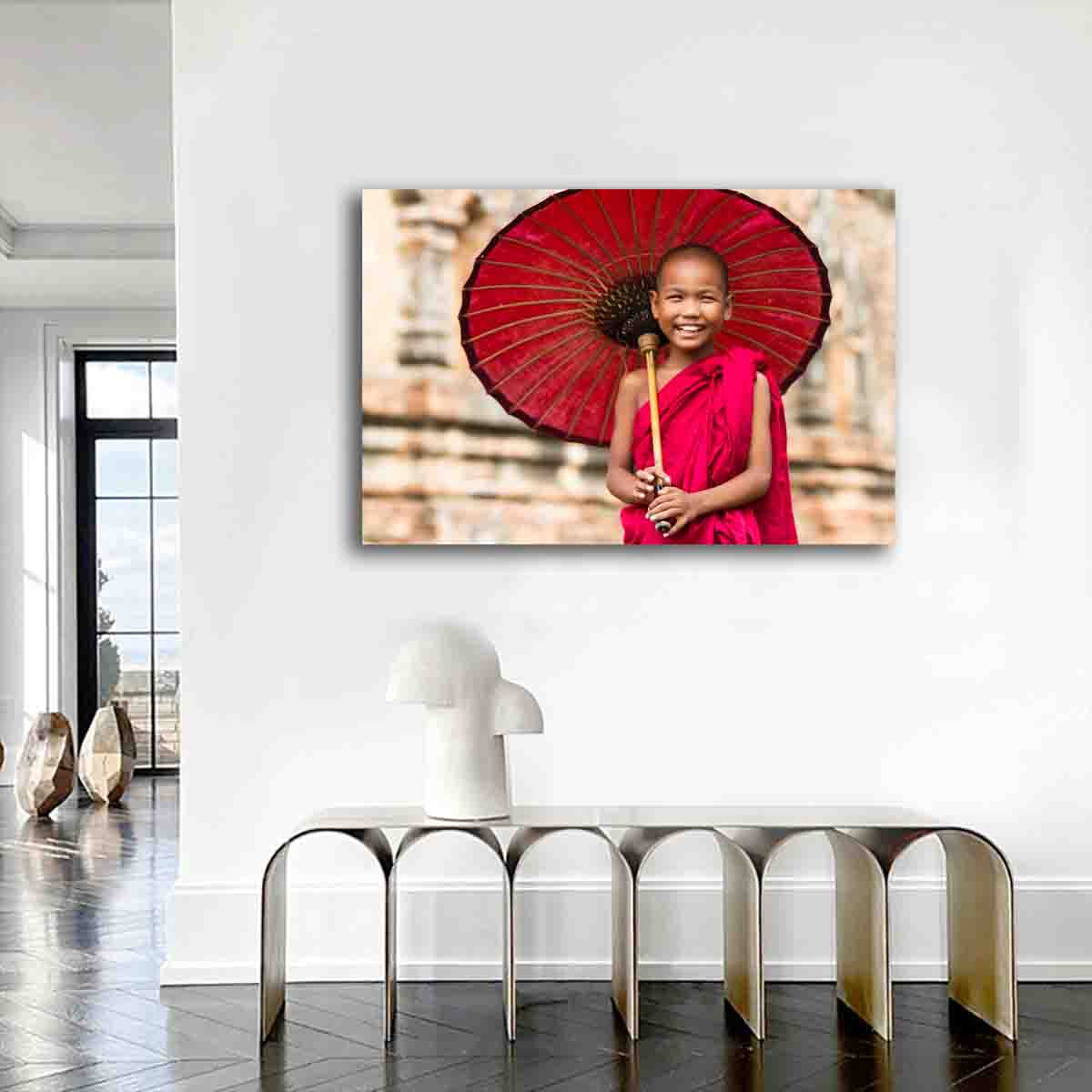 Fine art print of a novice monk standing in a Myanmar temple, displayed in a peaceful, modern interior space.