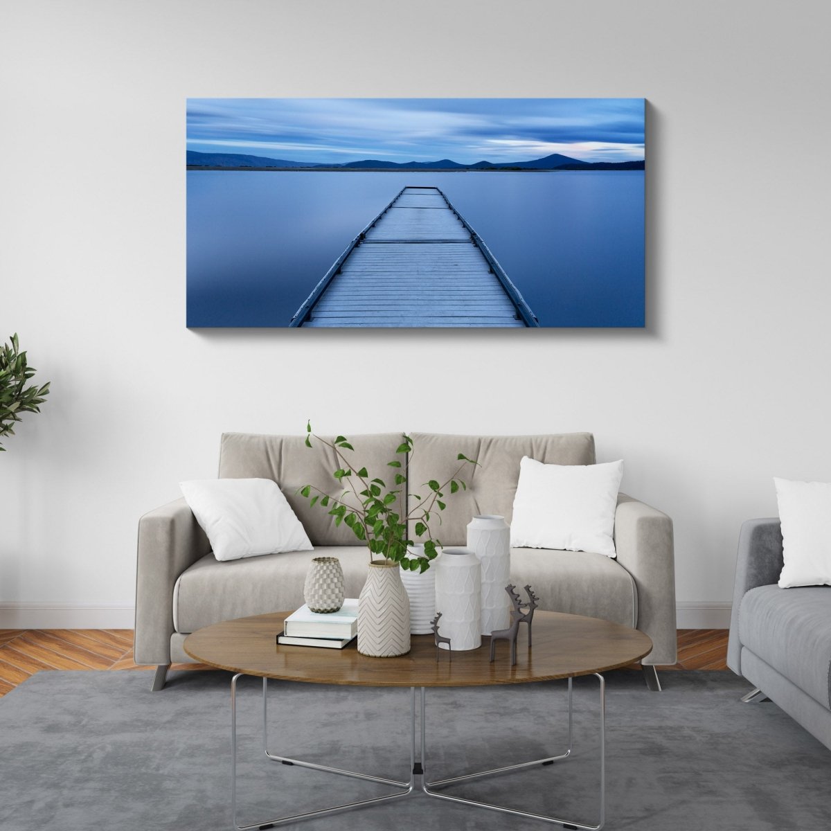 Oregon Jetty fine art print of a lakeside sunrise displayed in a modern interior, featuring calm water and a rocky jetty at dawn.