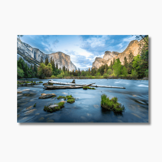 Sunset landscape photograph of Yosemite National Park featuring Yosemite Falls bathed in golden light.