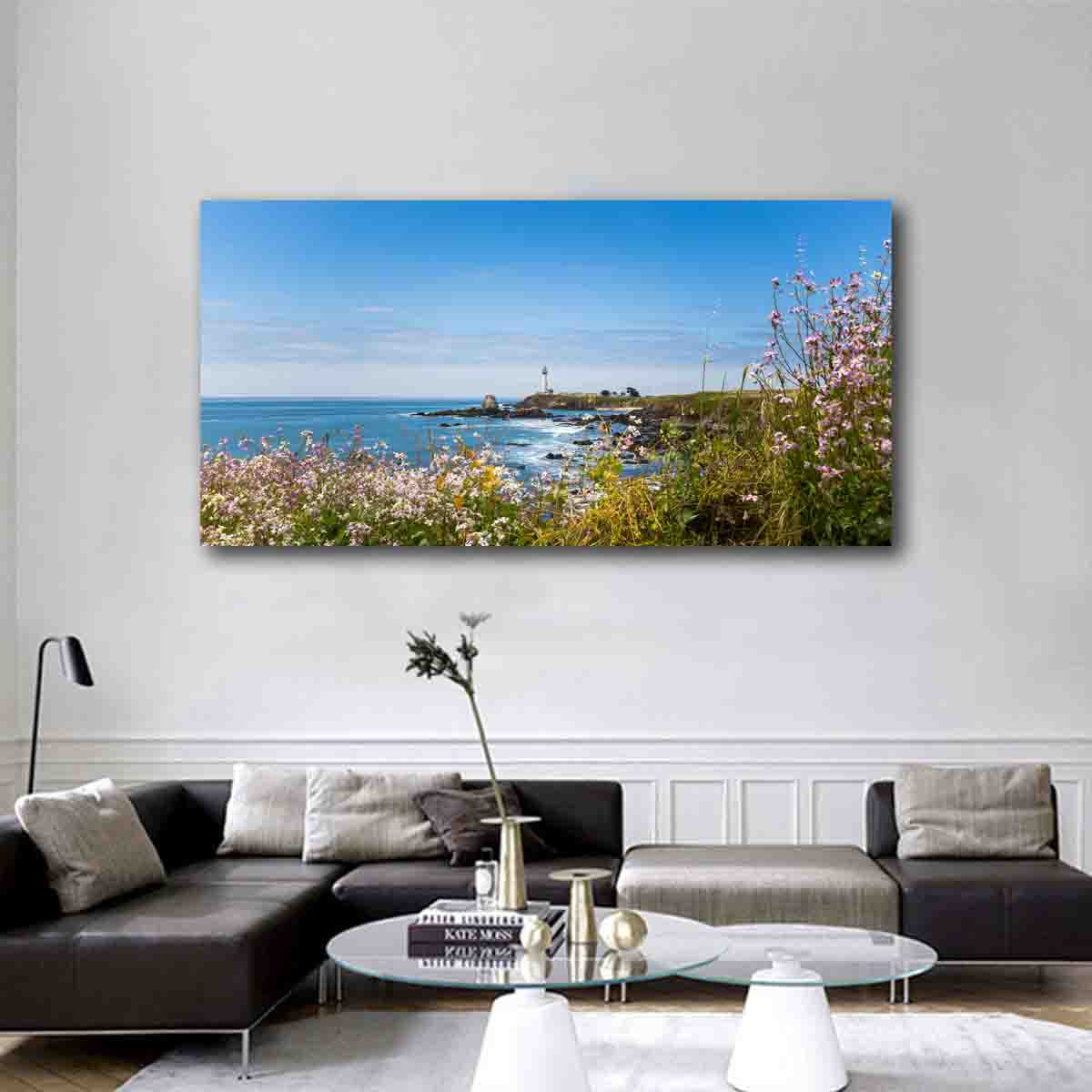 Coastal Harmony lighthouse wall art print displayed in a beach-themed interior with natural wood and soft neutral styling.