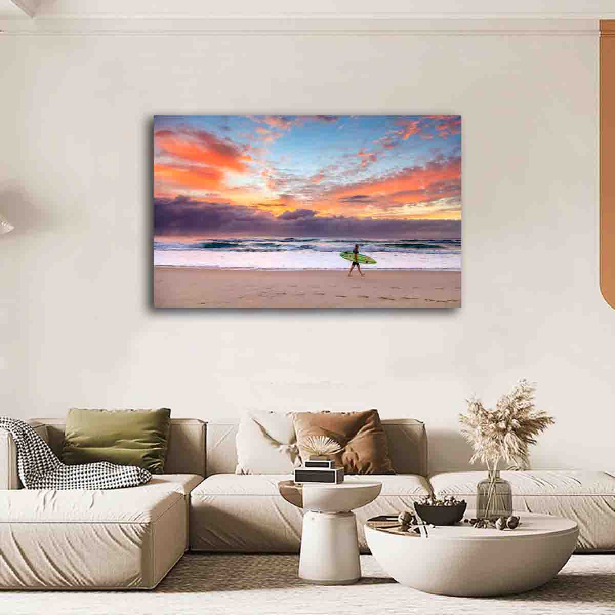 Fine art wall print of a surfer at sunrise on the Gold Coast, displayed in a serene coastal-inspired room.