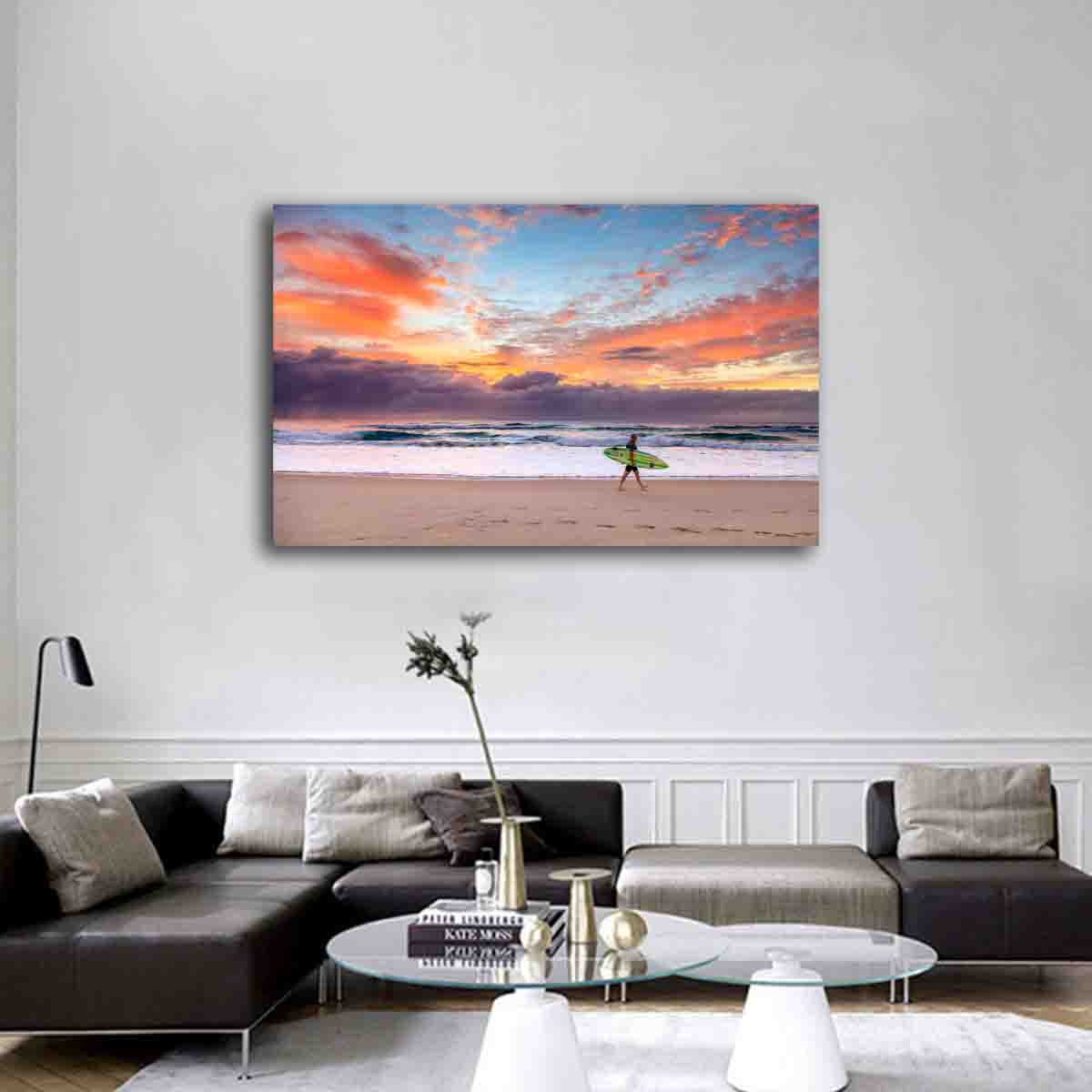 Fine art wall print of a surfer at sunrise on the Gold Coast, displayed in a serene coastal-inspired room.